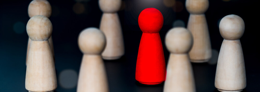assorted chess pieces with one red